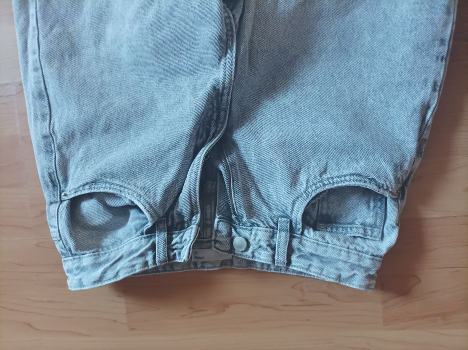 Spodnie jeansowe, poszarpana nogawka