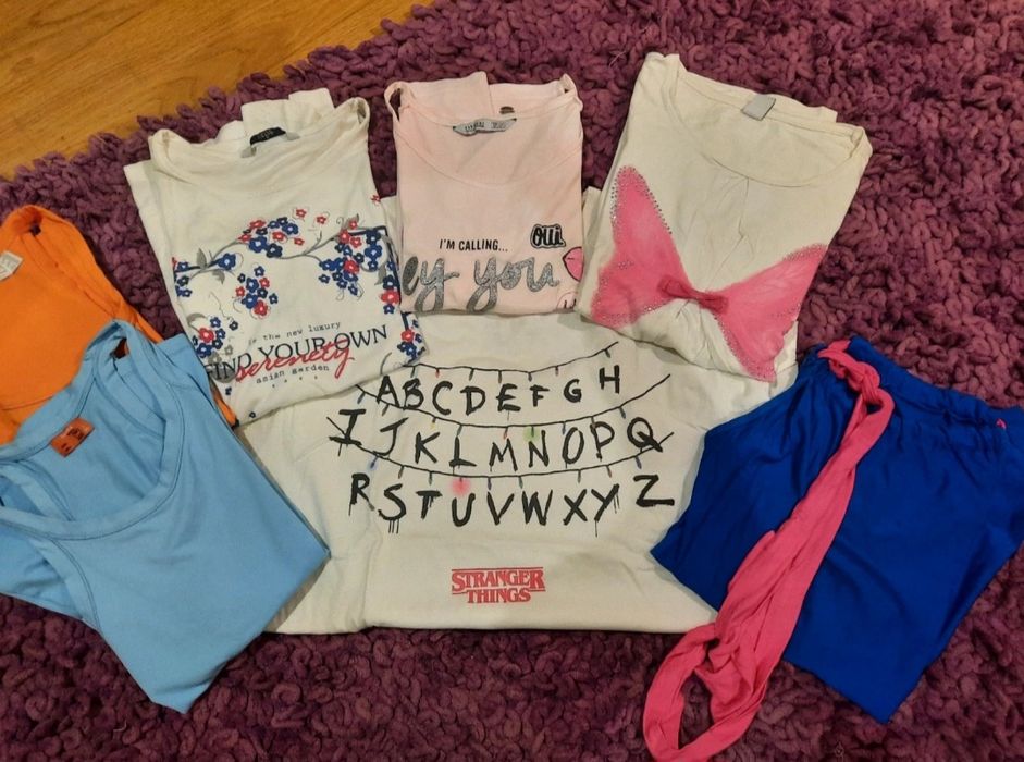 Sete t-shirts = 7,00€. A idade mais aproximada é 13 anos