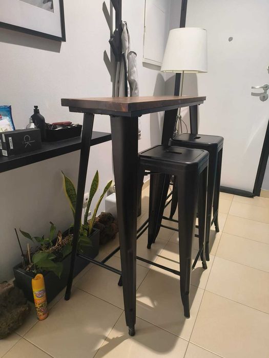 Mesa alta com tampo de de madeira natural e duas cadeiras