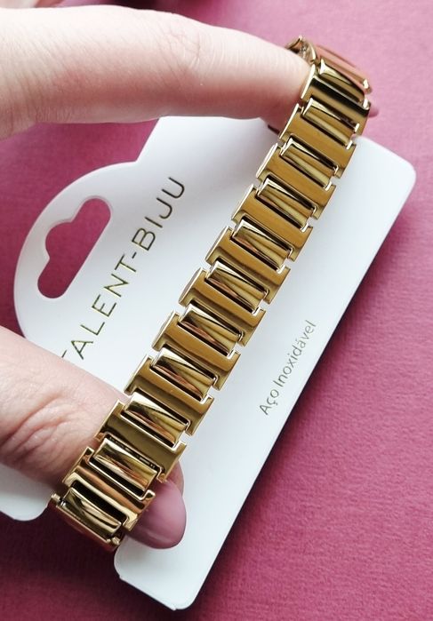 Pulseira elástica, dourada, em aço inoxidável.