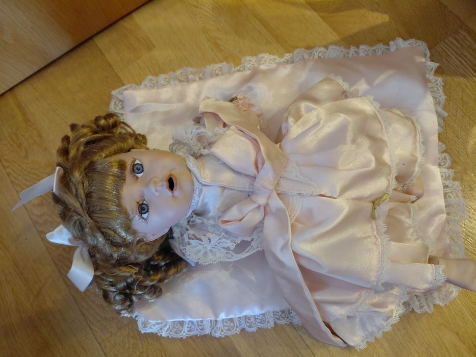 Boneca de porcelana com almofada