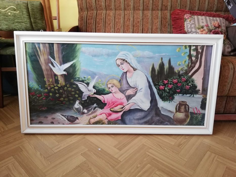Stary obraz o tematyce religijnej w białej ramie