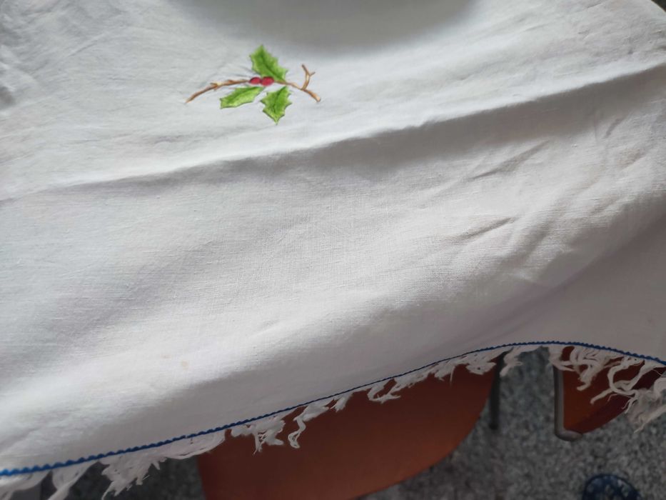 Toalha de natal branca com bordados natalícios.