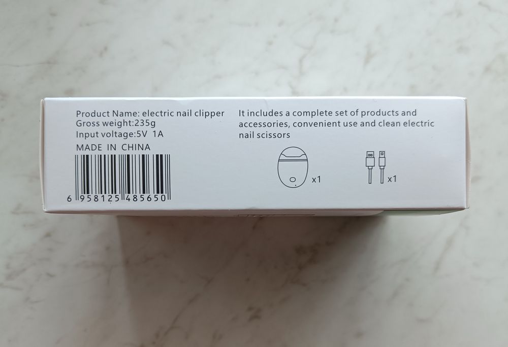 Электрическая машинка для стрижки ногтей.