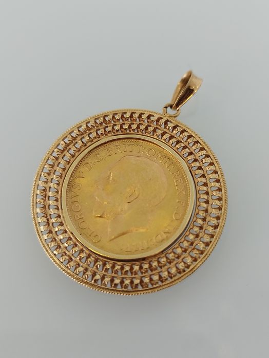 Medalha libra em ouro de 22kt com aro de 19,2kt
