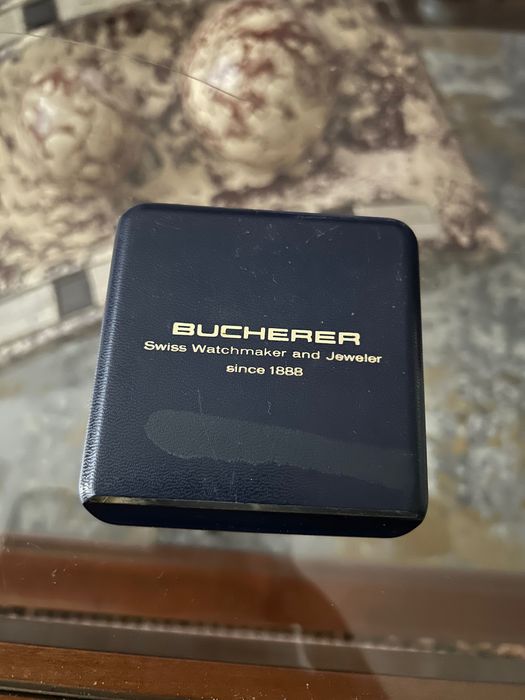 Isqueiro a gasolina em plaquê ouro com relógio a corda Bucherer
