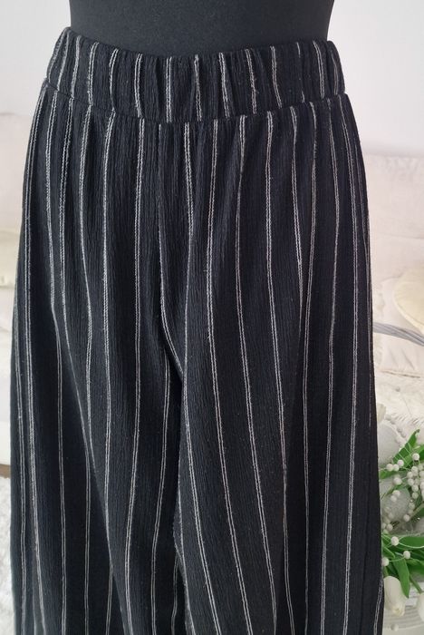 Spodnie szerokie nogawki H&M".