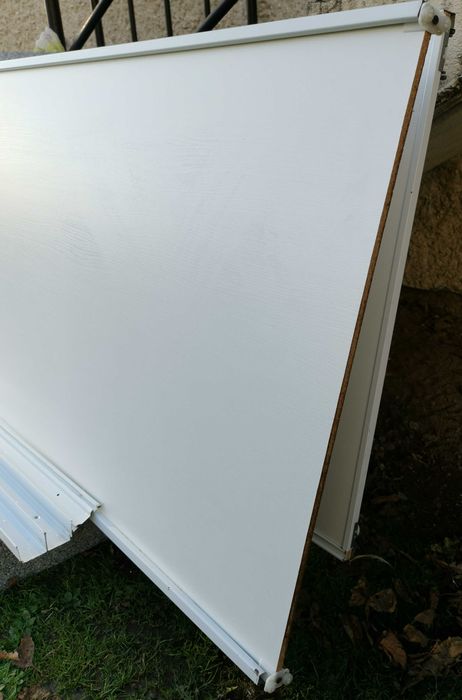Drzwi przesuwne dwuskrzydłowe, białe. Szer. skrzydła 76cm, wys. 231cm.