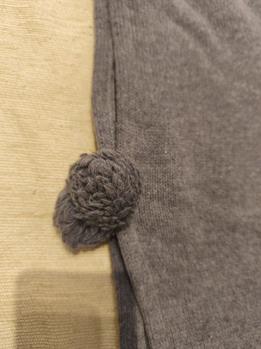 capa com pompons cinzenta