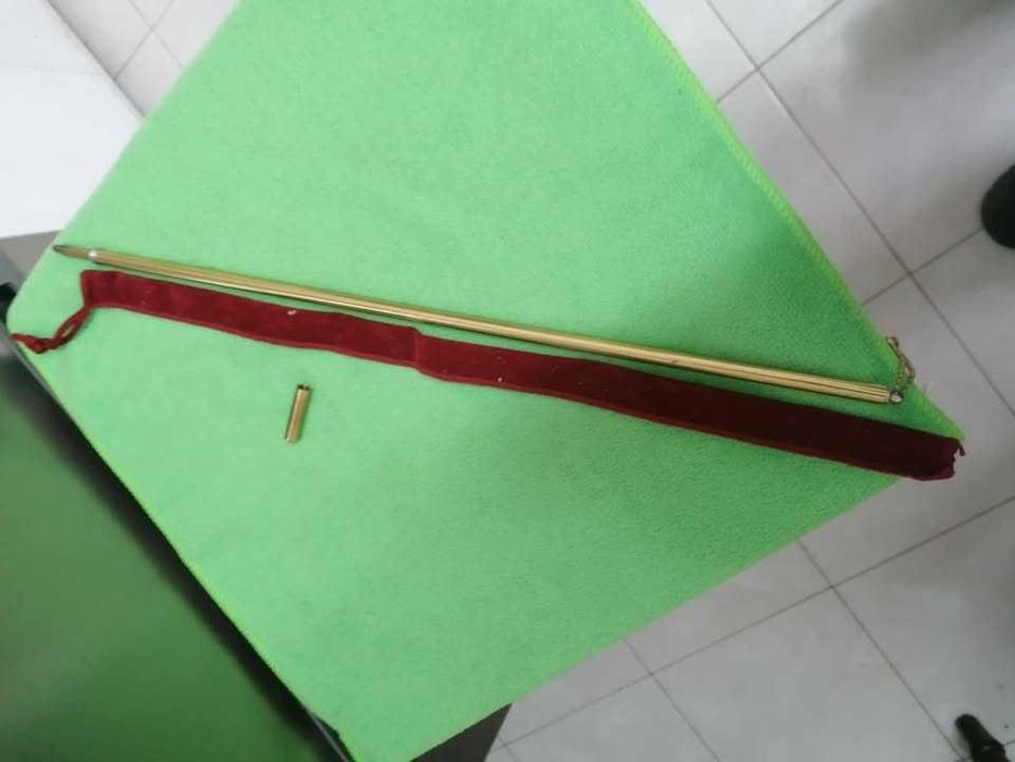 Brass cigarette lighter in rod shape.