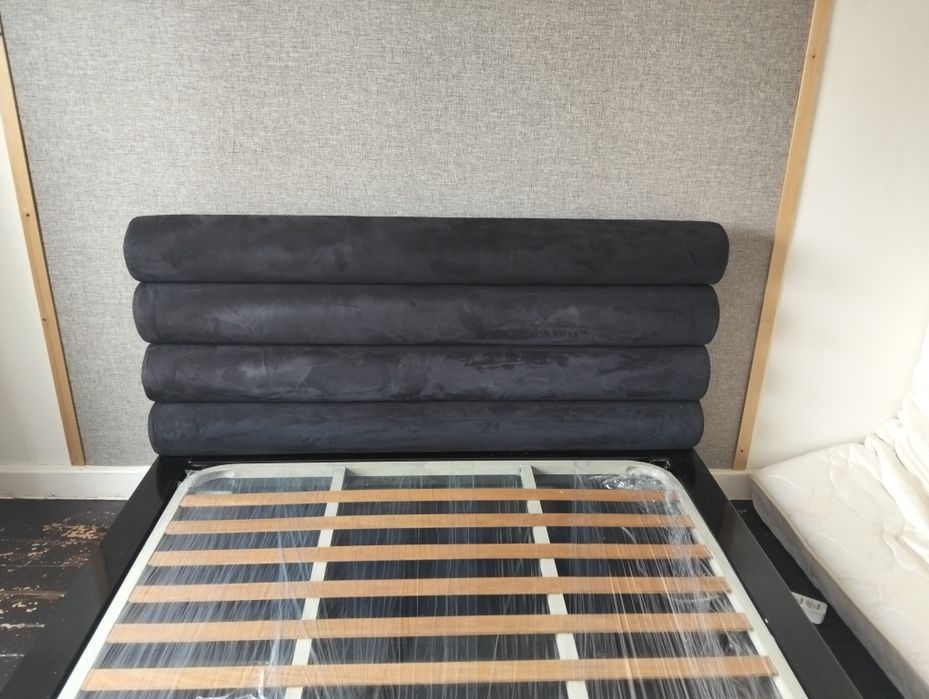 Uma cama casal com estrado e colchão