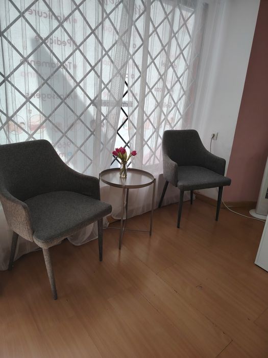 Duas cadeiras e mesa de apoio
