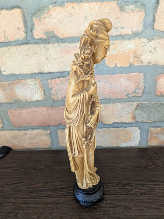 Decoração artesanal origem Ásia mulher com arranjo de flores