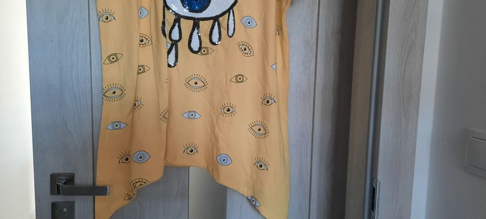 Ładna tunika kolor blady żółty z okiem z cekinami