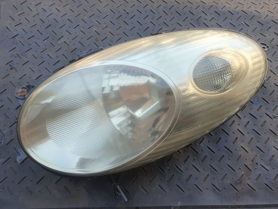 NISSAN MICRA K12 REFLEKTOR LAMPA LEWY PRZÓD LEWA PRZEDNIA 26060AX700 89007101 ORYGINAŁ