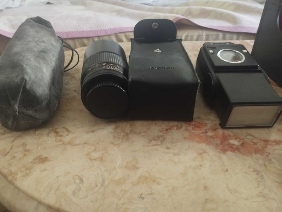 Maquina fotográfica Canon A-1 com uma lente de 100 Metros