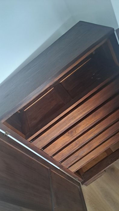 Armário antigo com entalhes florais e prateleiras