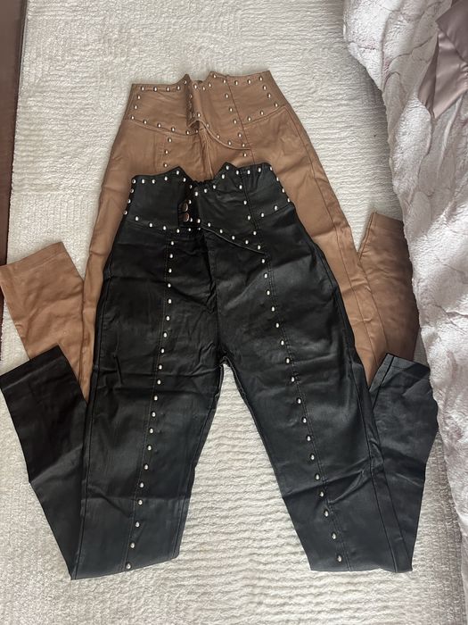 Calcas de napa pretas e castanhas