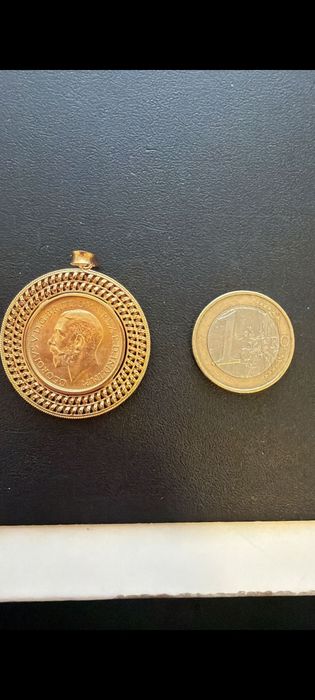 Medalha libra em ouro de 22kt com aro de 19,2kt