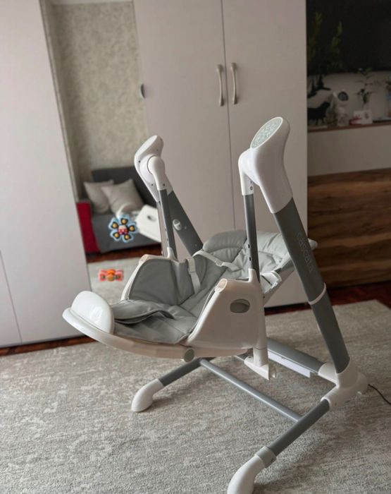 Cadeira de balanço com uma mesa de alimentação.