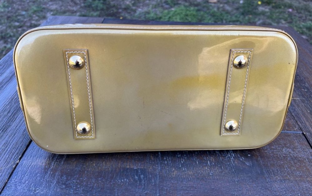 Mala  bolsa Louis Vuitton Alma PM dourada