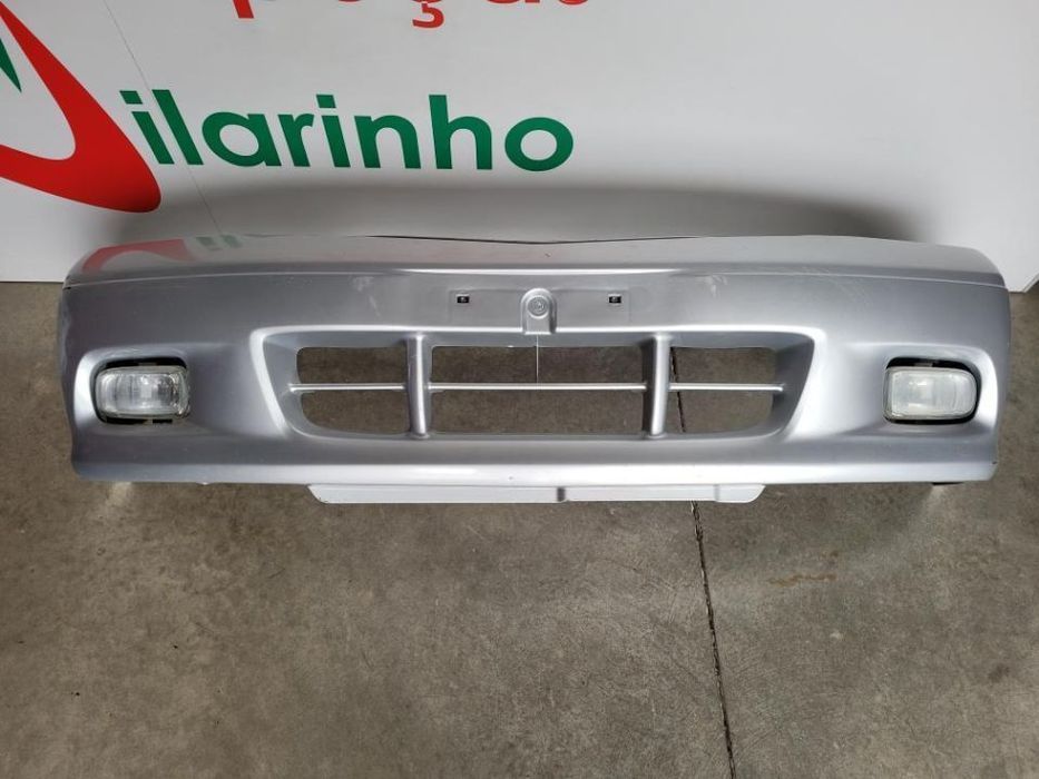 Para choques Mazda Demio 2001