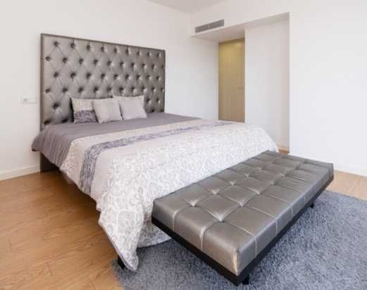 Cama cinza com banqueta e colchão