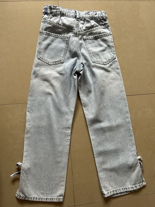 Jeansy Reserved z kokardkami rozm 140