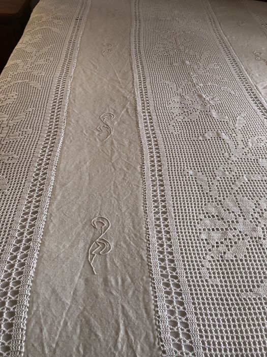 Hand-crocheted bedspreads with different designs, one made of linen