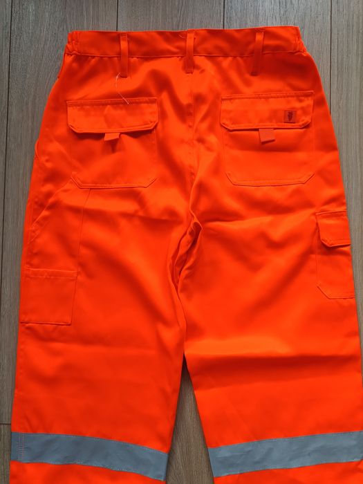 Męskie spodnie robocze pomarańczowe odblaskowe jak nowe Warrior