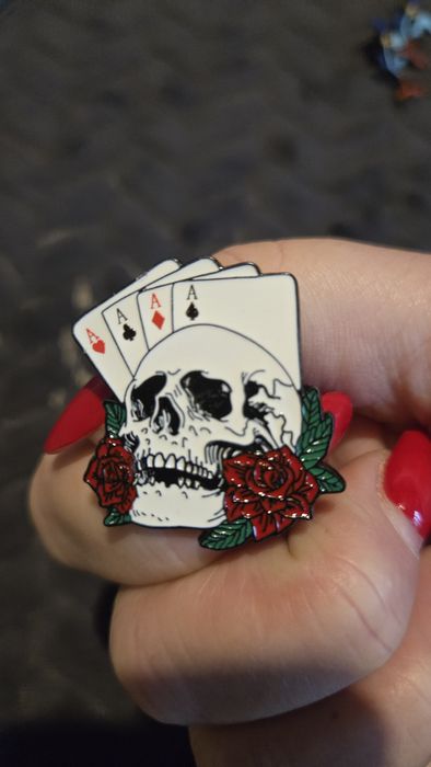 Przypinka karty i czaszka.