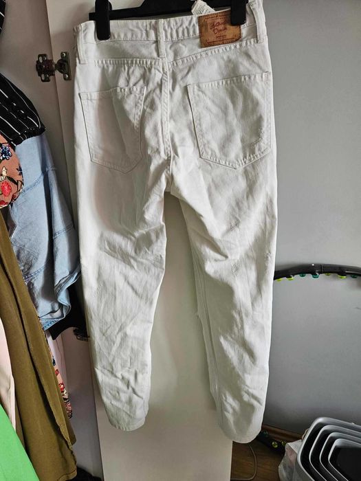 Białe spodnie mom jeans z dziurami