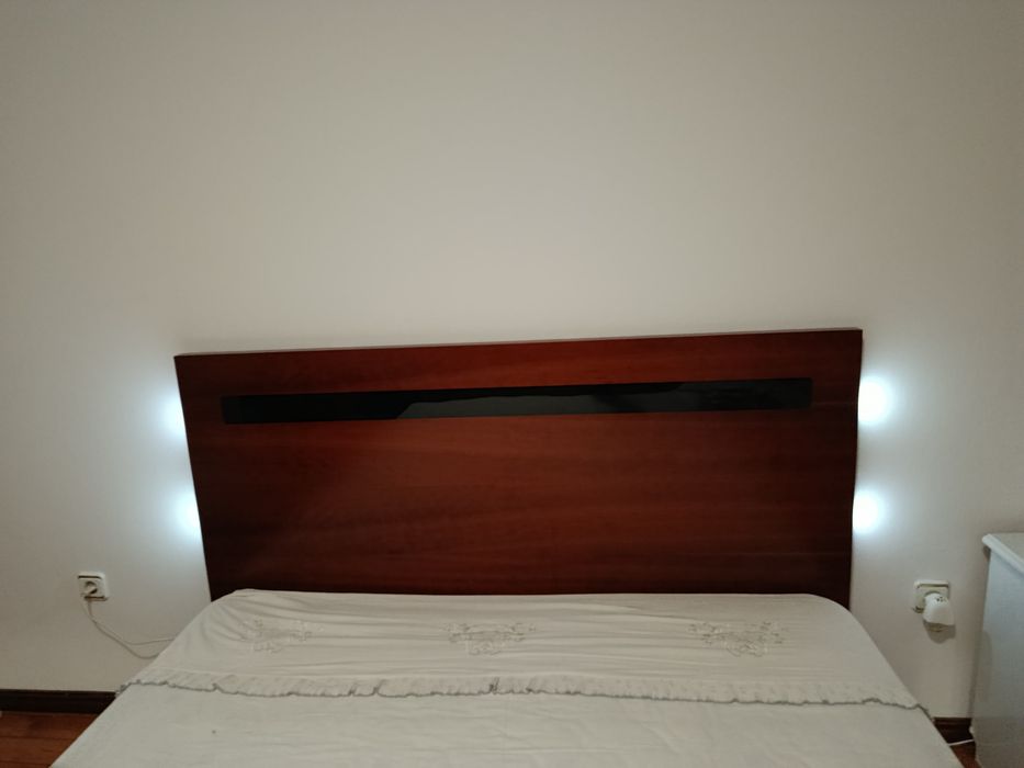 Cama grande de casal, com arrumação.