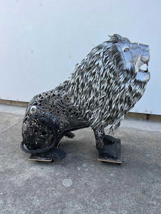 Leão sentado em metal reciclado
