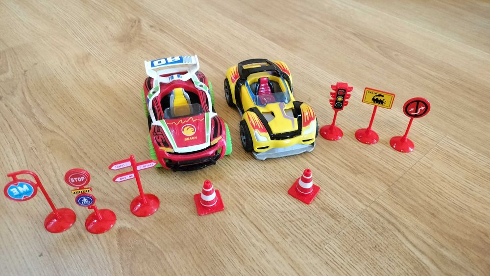 Dwa auta ze znakami drogowymi