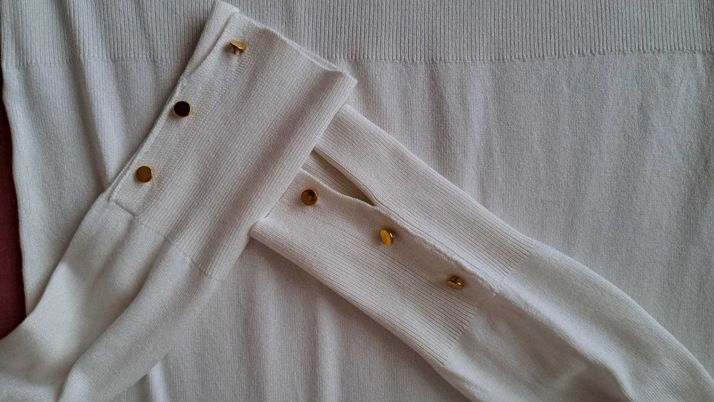 sweter w kolorze mlecznym.