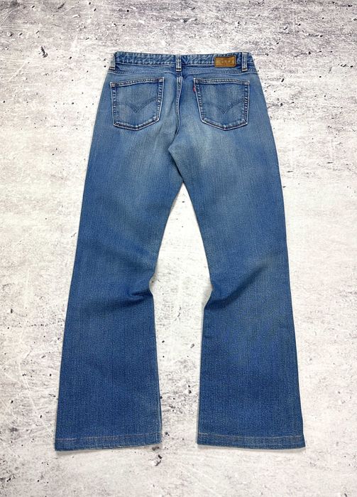 Spodnie jeansowe LEVIS 553 Mid-Rise Boot dzwony damskie szerokie W29