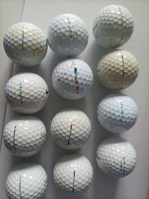 Bolas de golfe e vários tacos de golfe