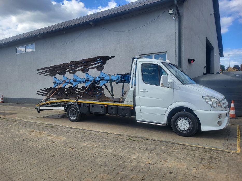 Transport maszyn , pomoc drogowa , auto holowanie , autolaweta .