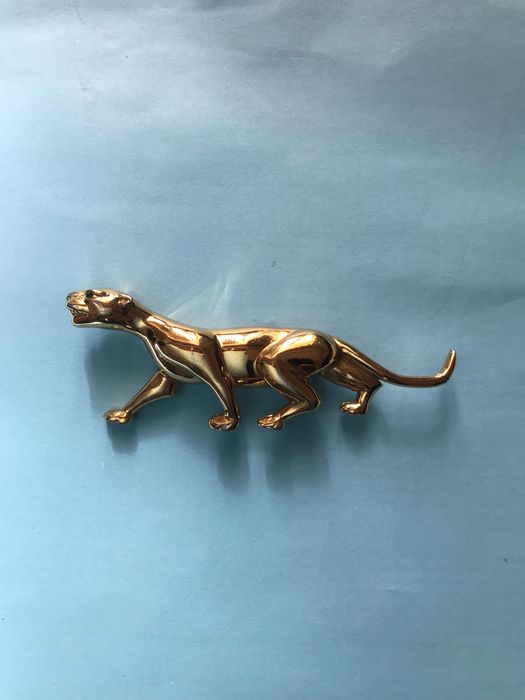 Pregadeira dourada da marca Nina Ricci