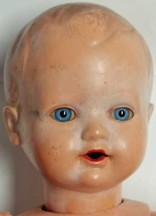 boneco antigo que mexe a cabeça quando se movimenta os braços