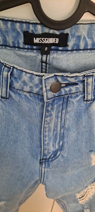 Niebieskie spodnie jeansowe z dziurami Missguided  r.36