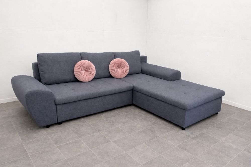 Szary narożnik rozkładany z funkcją spania używany transport