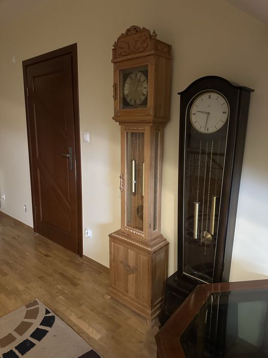 stylowy zegar stojący – jasne drewno, rzeźbiony(ten po lewej)