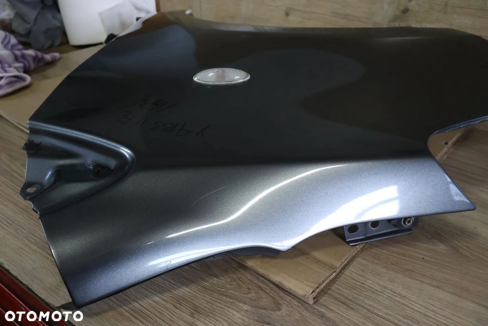 TOYOTA YARIS II 2 LIFT 09-11 BŁOTNIK LEWY PRZÓD PRZEDNI 1G3 - 7