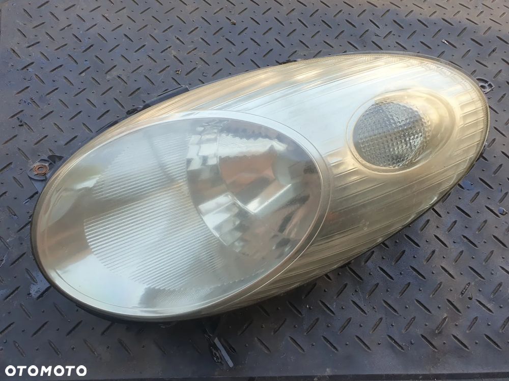 NISSAN MICRA K12 REFLEKTOR LAMPA LEWY PRZÓD LEWA PRZEDNIA 26060AX700 89007101 ORYGINAŁ - 1