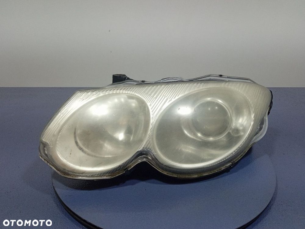 CHRYSLER 300M REFLEKTOR LEWY LAMPA EU 04780003AC - 1