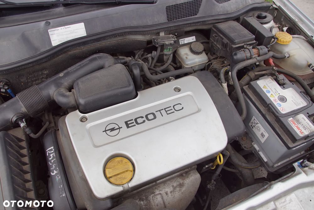 Auto na części - Opel Astra II G 1.6 16V 101 KM X16XEL F17 Z147 1999R Silnik Skrzynia Drzwi Maska Błotnik Zderzak Klapa Lampa Lusterko Klamka Szyba Deska Kokpit Sterownik Moduł Czujnik Licznik Panel Kierownica - 19
