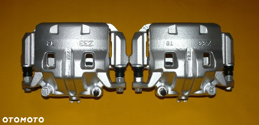 ZACISKI JARZMA LEWY PRAWY PRZÓD NISSAN PATHFINDER III 3 R51 296/28mm 04-10r - 9
