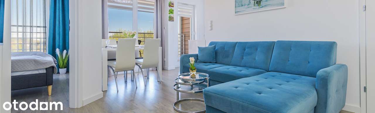 Stylowy apartament z balkonem i widokiem na zieleń i latarnie morską